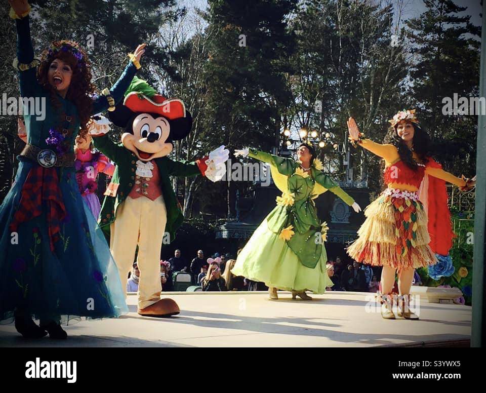 Mickey Mouse dressed as a pirate with Moana, Merida and Princess Tiana on stage during a parade show in Disneyland Paris Stock Photo