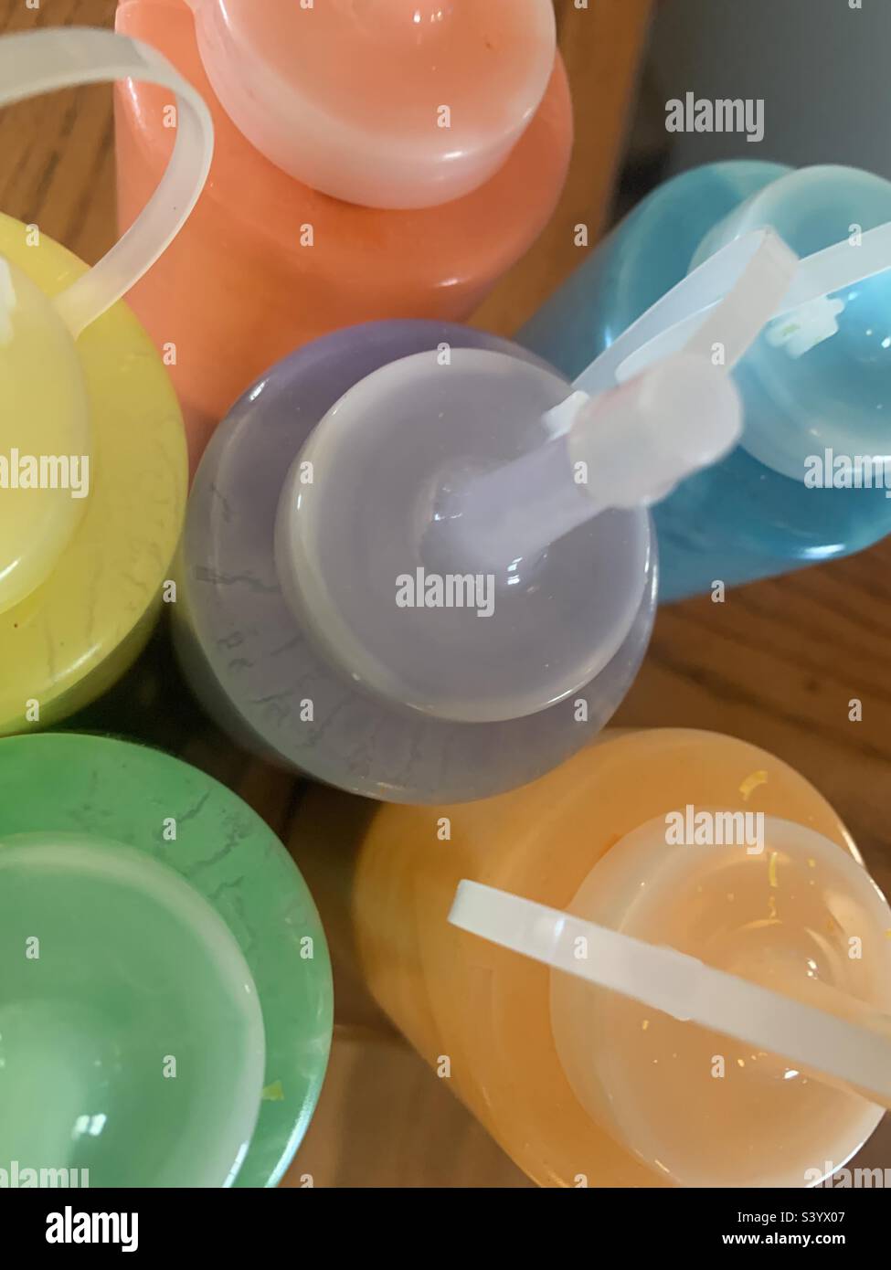 Squeeze bottles filled with bright pastels - Smartphone Captured Stock Image