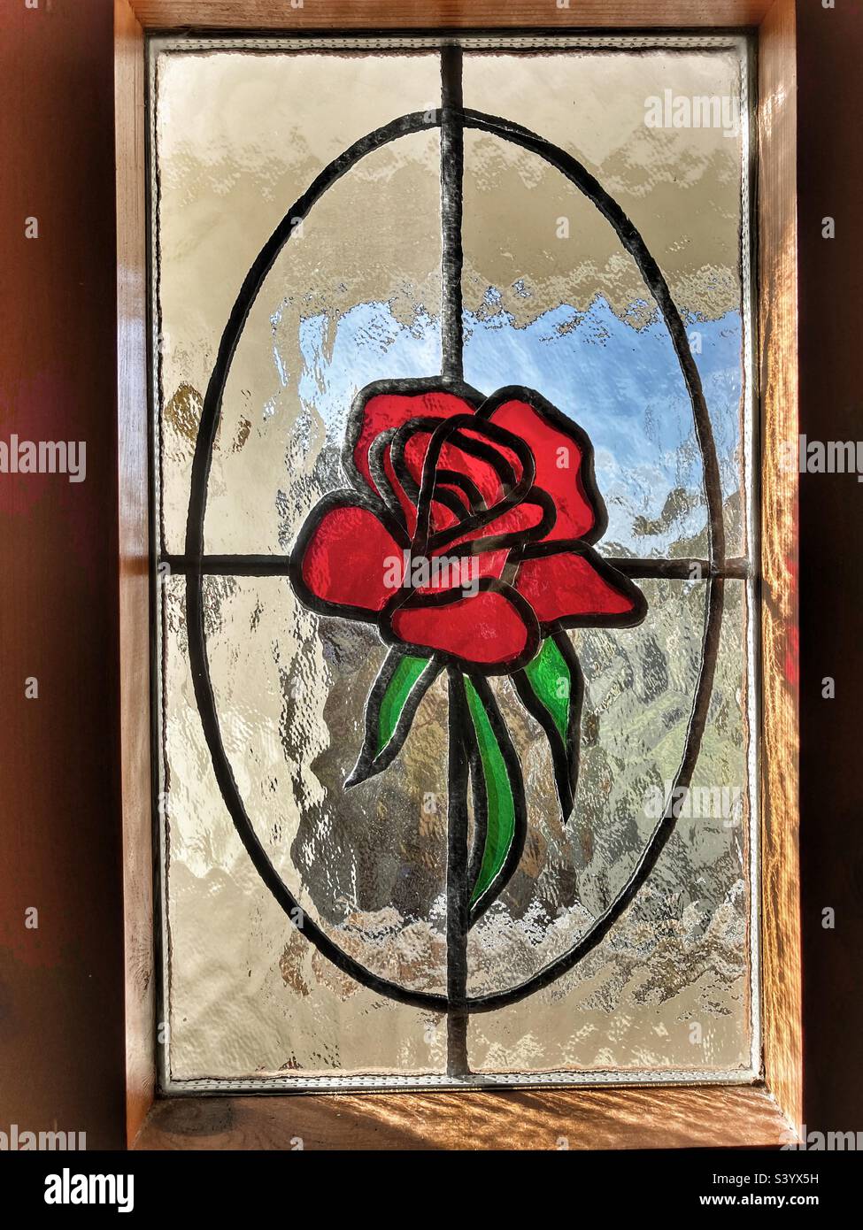 Red rose in stained glass window Stock Photo