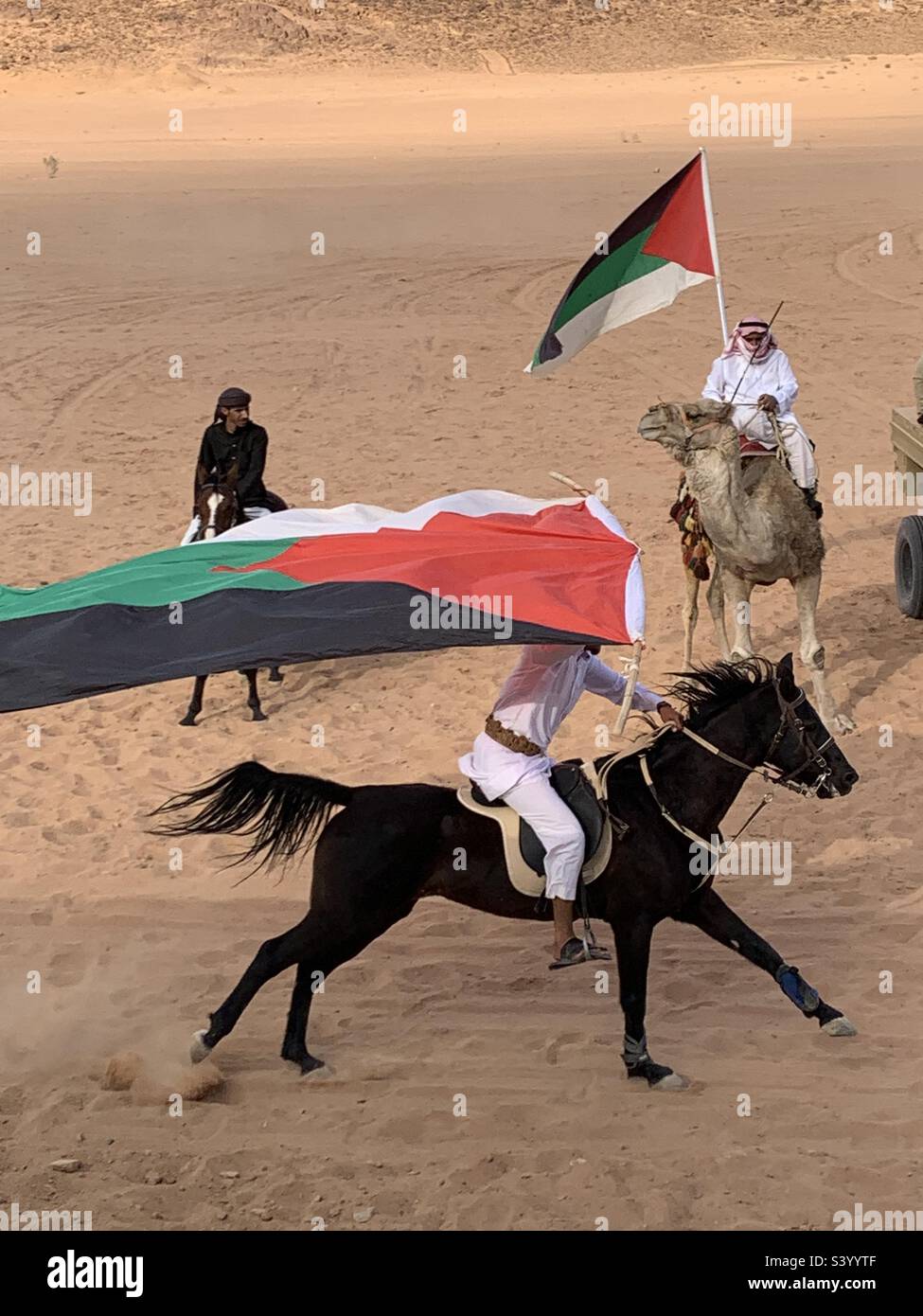 Man on horseback waving the Jordanian flag - Smartphone Captured Stock Image