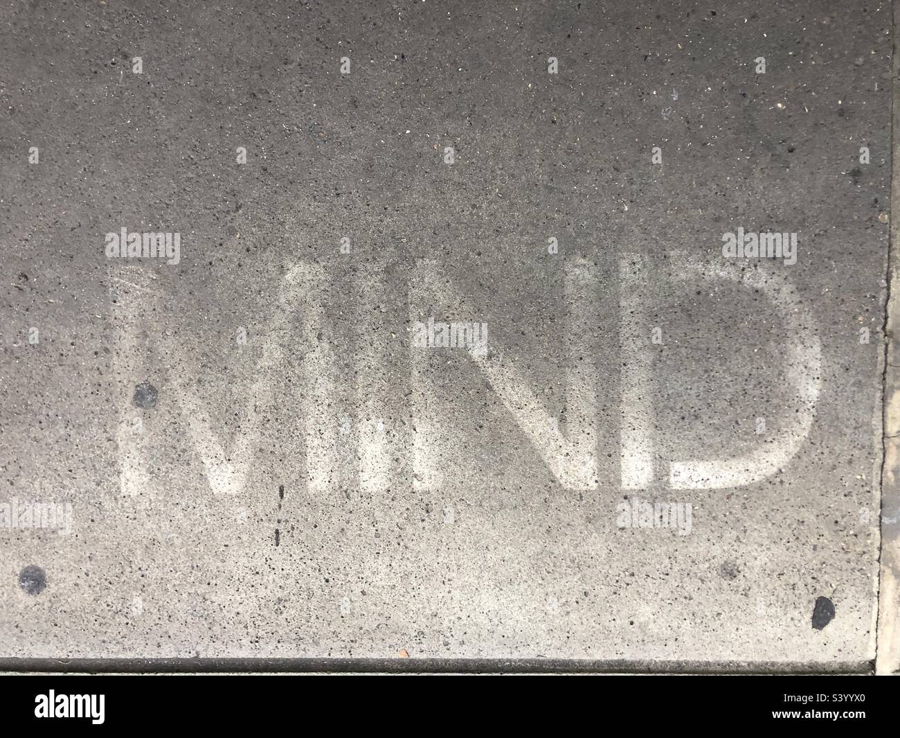 The word mind written on a fainted print on a slab - Smartphone Captured Stock Image