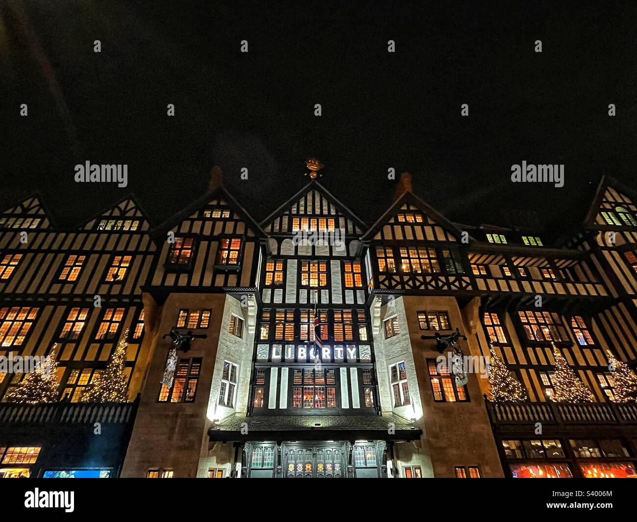 Liberty’s department store opened in 1875 located at Great Marlborough Street it is mock Tudor facade - known for championing younger designers fashion and home furnishings seen at night - Smartphone Captured Stock Image