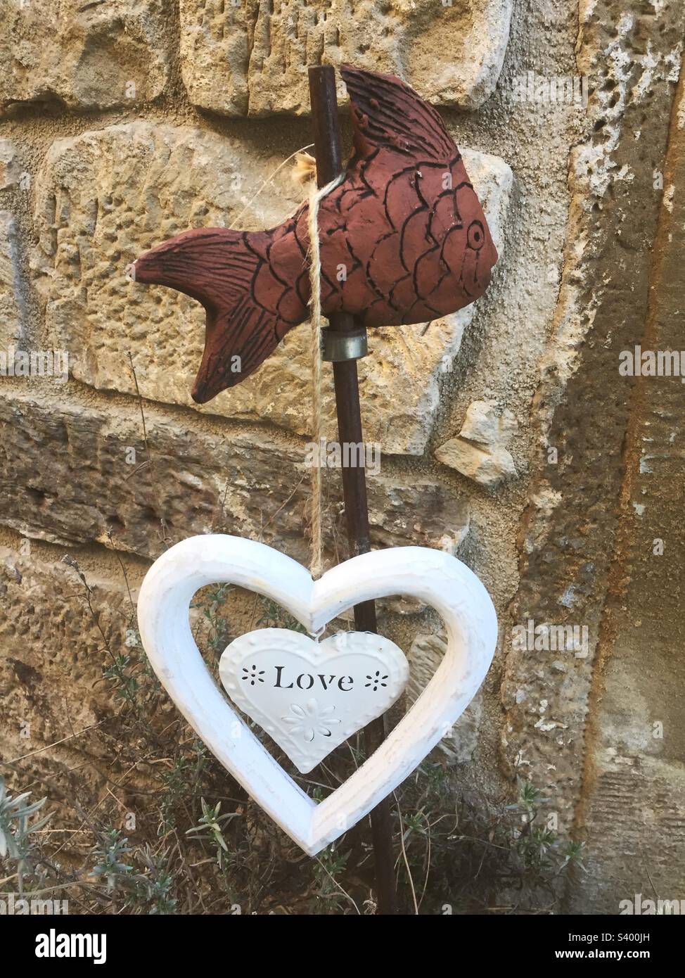 Outdoor decoration with a white heart and the text love - Smartphone Captured Stock Image