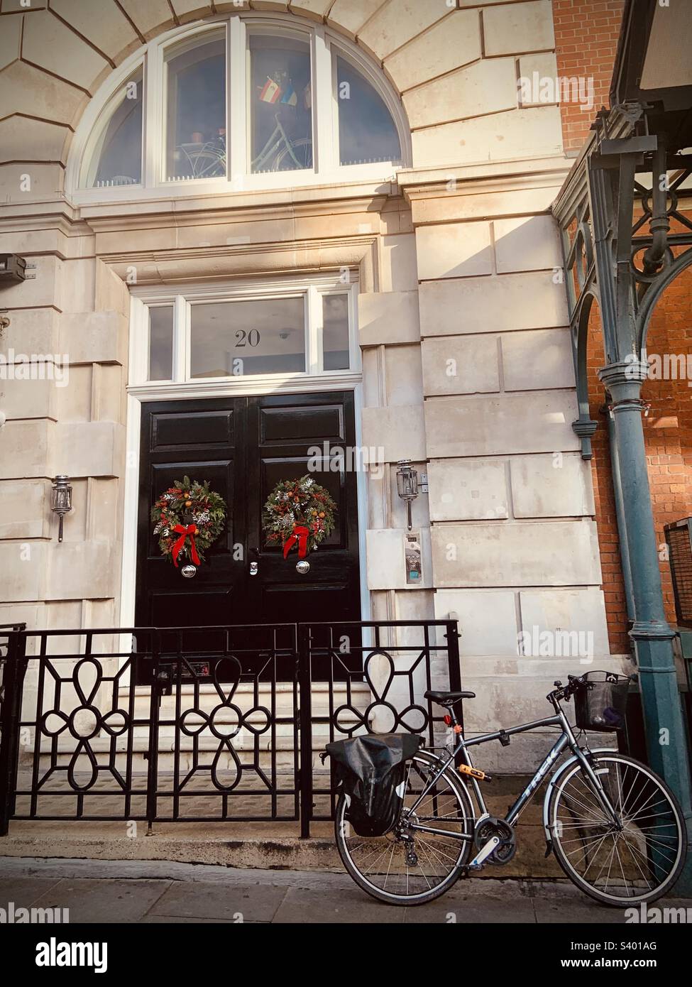 A bicycle outside a building in London, with Christmas wreaths hanging