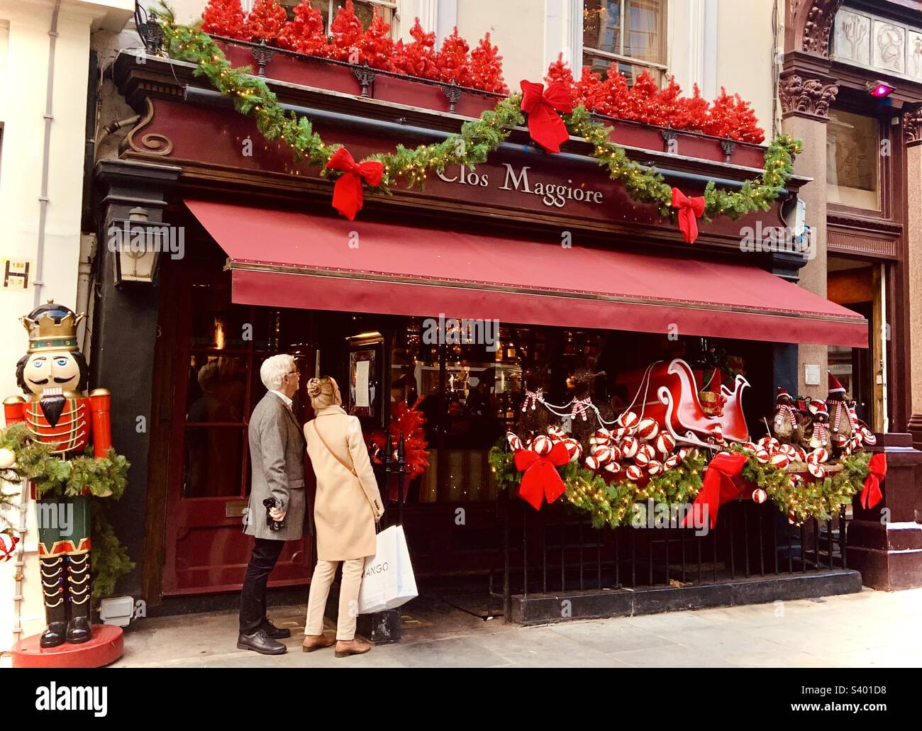 People looking at the menu in a restaurant window. Christmas 2022 in