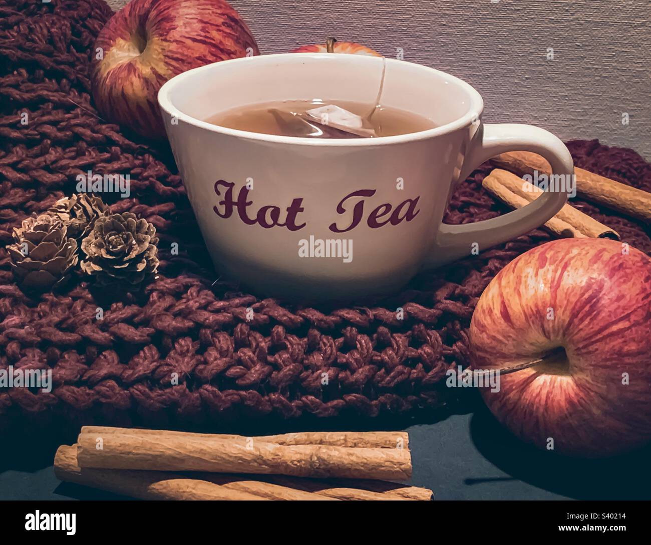 Apple & Cinnamon tea, shown with fruit & spice on knitwear Stock Photo