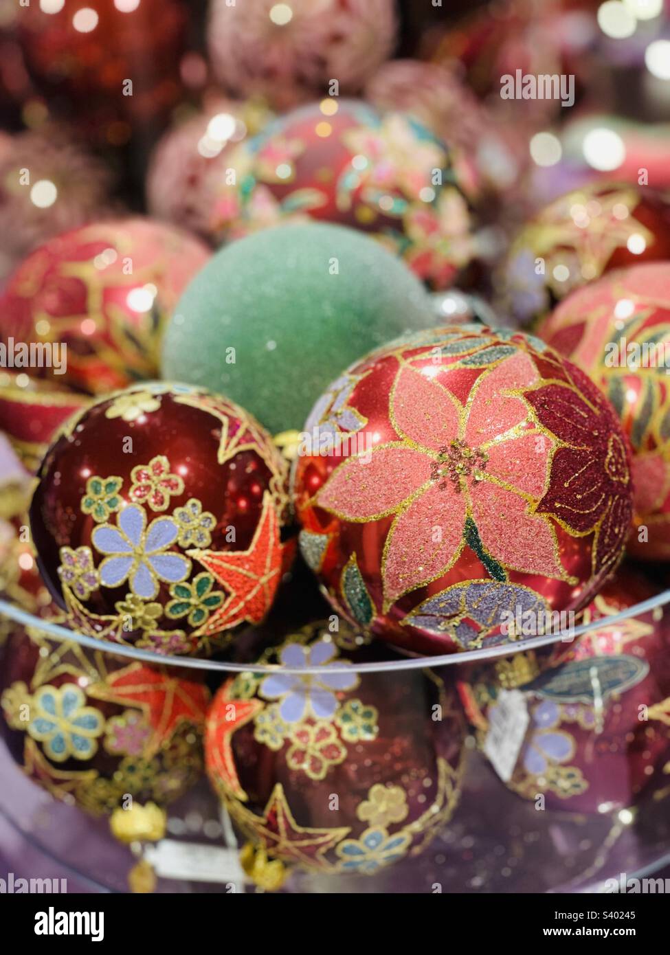 Hand painted glass Christmas balls in a transparent bowl Stock Photo