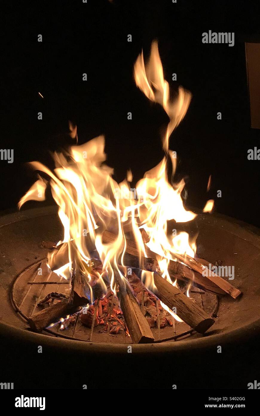 Roaring fire in a fire pit on a winter’s night Stock Photo Alamy