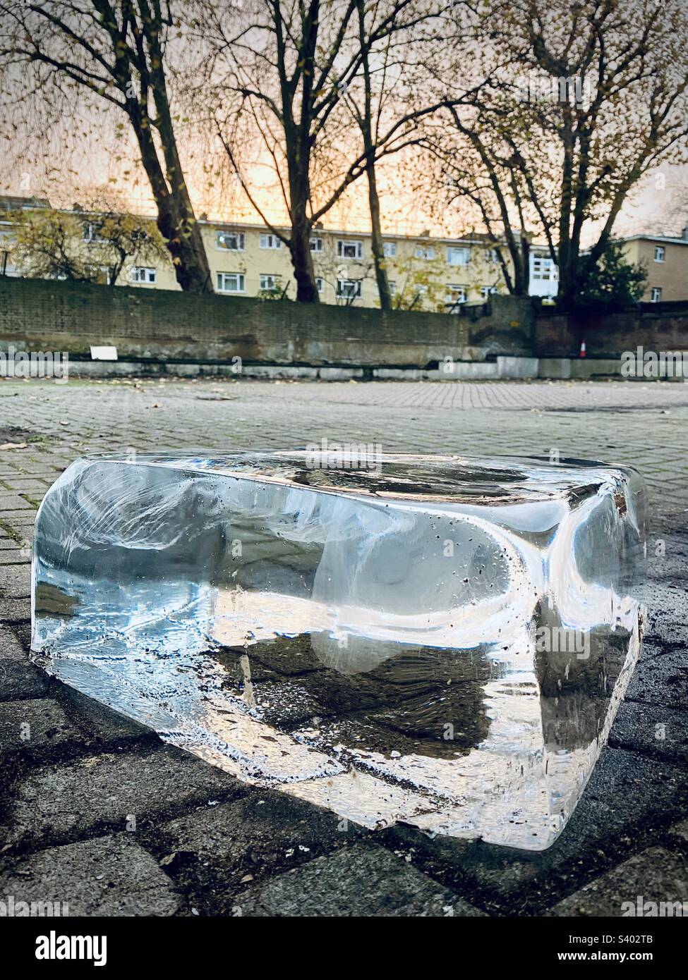 A large block of ice on the floor of a carpark waiting for collection