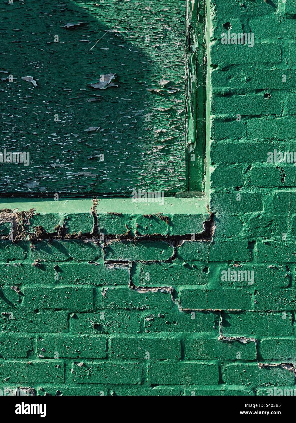Green painted brick wall with boarded up window Stock Photo Alamy