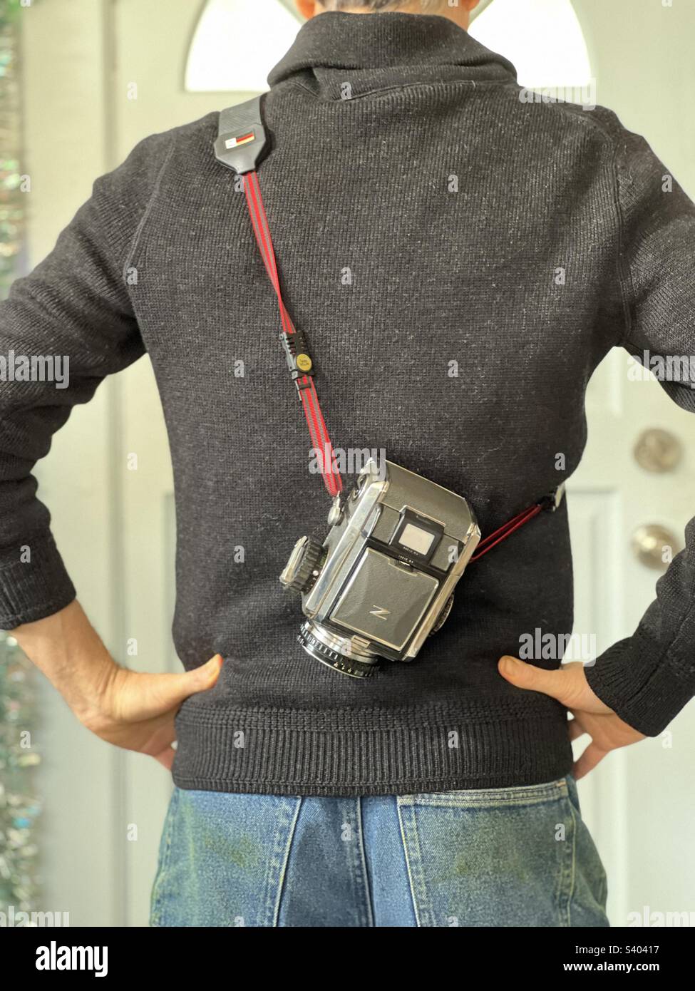 Man’s back with vintage medium format film camera - Smartphone Captured Stock Image