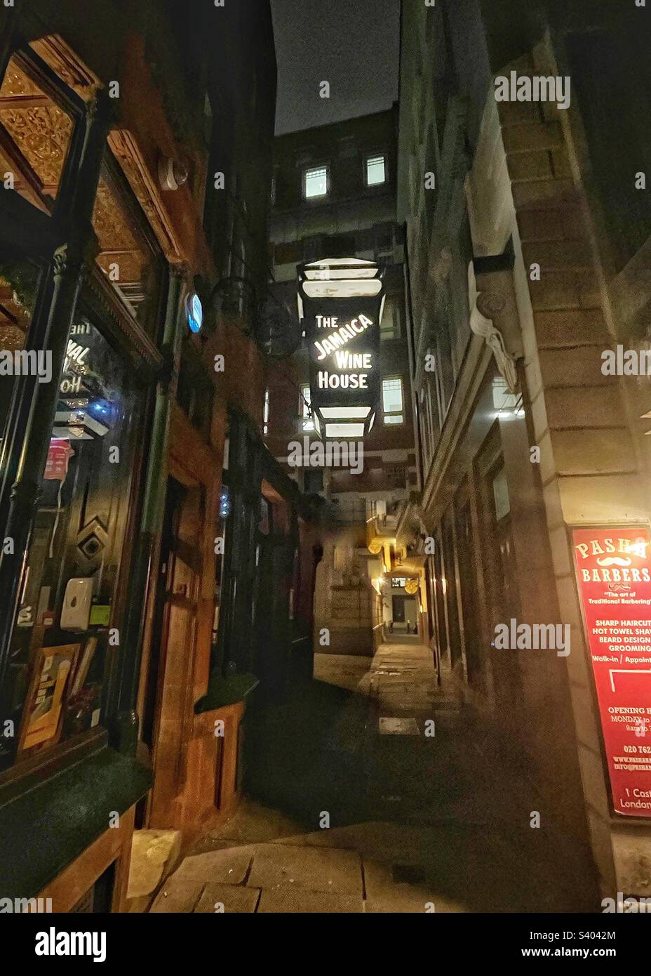 Narrow London passage with old street lantern advertisement The Jamaica Wine House, St Michael’s Alley, EC3 - Smartphone Captured Stock Image