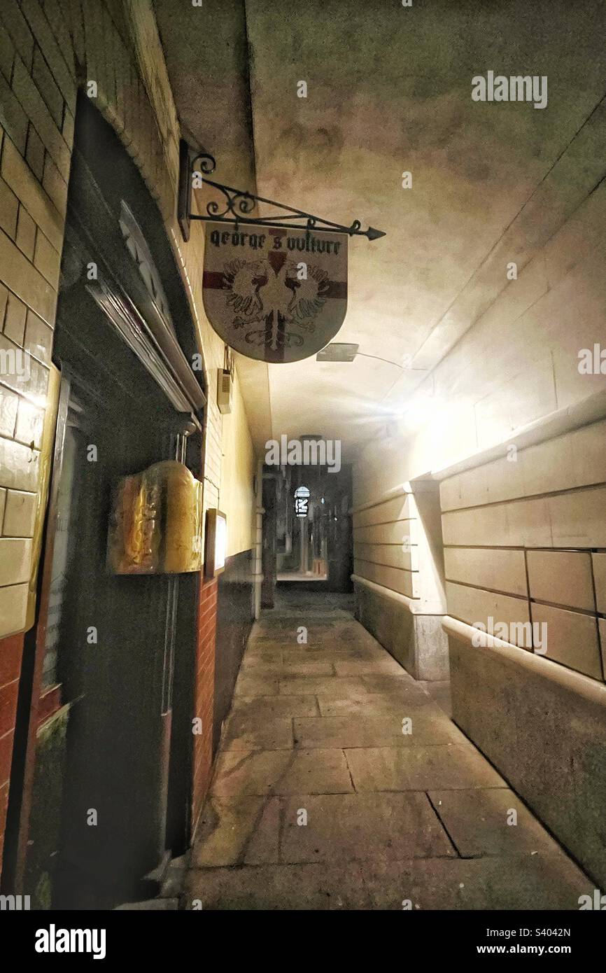 Old London passage with pub sign for George & Vulture there has been an inn on this site since 1142. Ghostly at night and a restaurant once frequented by Hell Fire Club - Smartphone Captured Stock Image