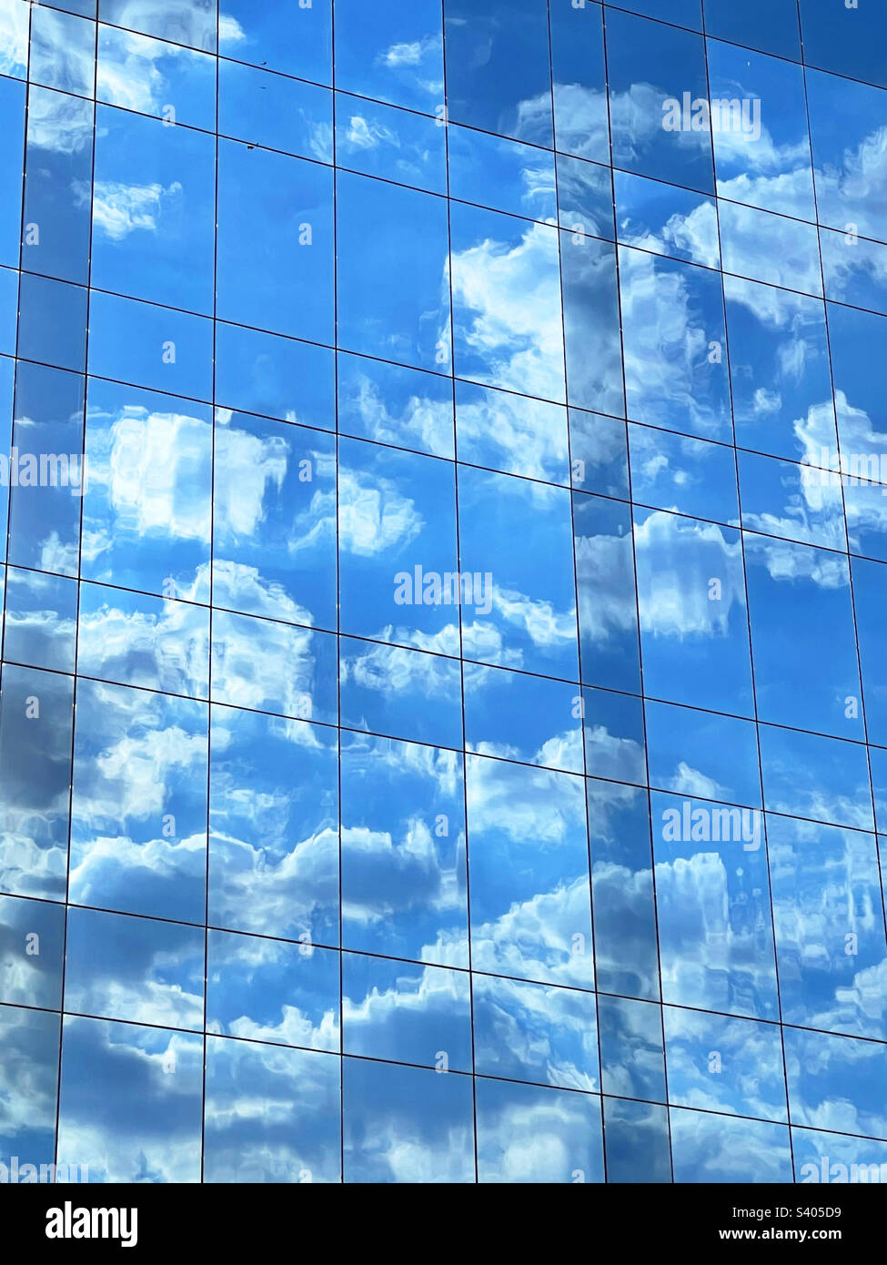 Sky reflected on glass facade. - Smartphone Captured Stock Image