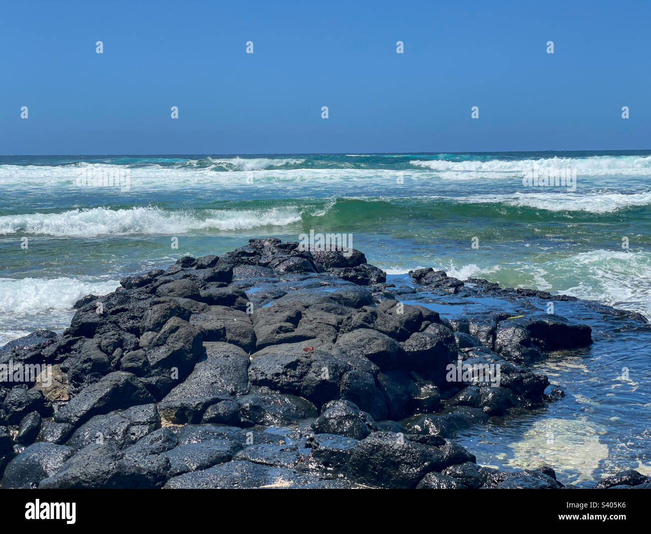 Rocks, reef lagoon and waves breaking at Poste LaFayette beach, Mauritius - Smartphone Captured Stock Image