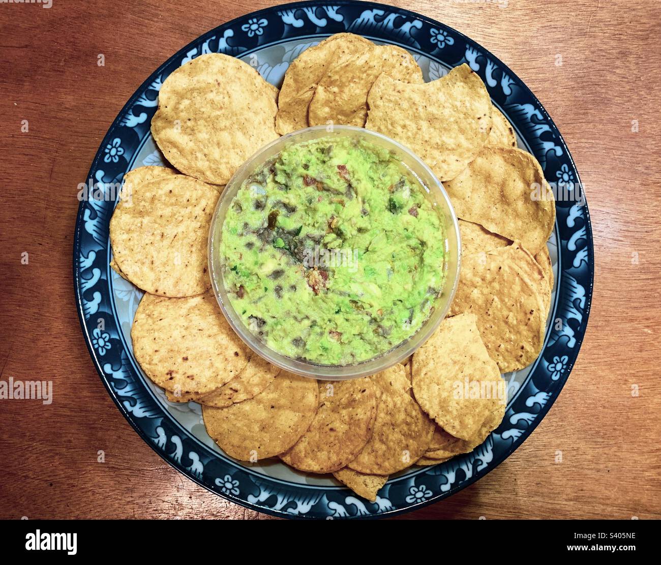 Guacamole dip and chips in a bowl Stock Photo