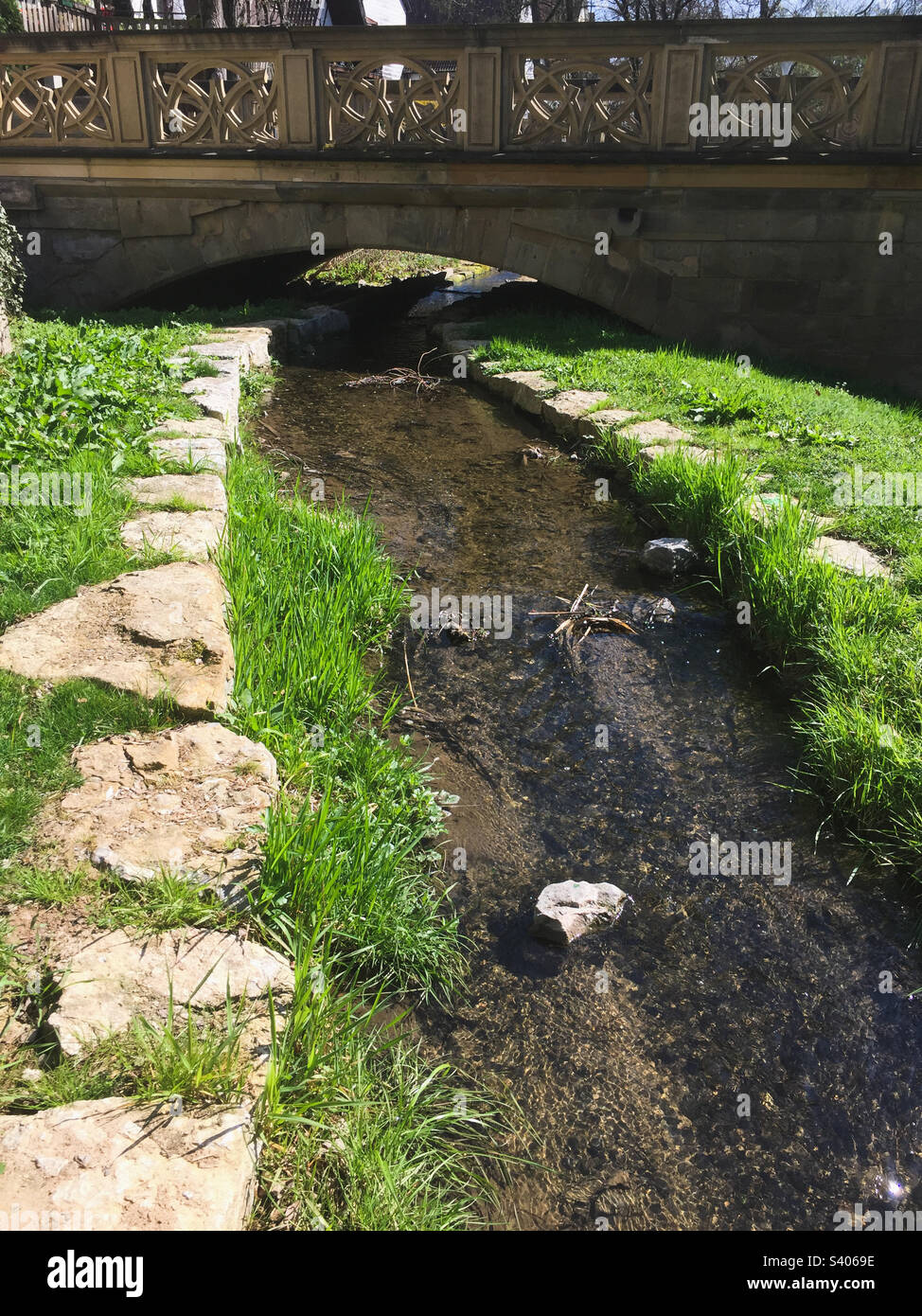 Small brook flowing under an old stone bridge - Smartphone Captured Stock Image Small brook flowing under an old stone bridge - Smartphone Captured Stock Image