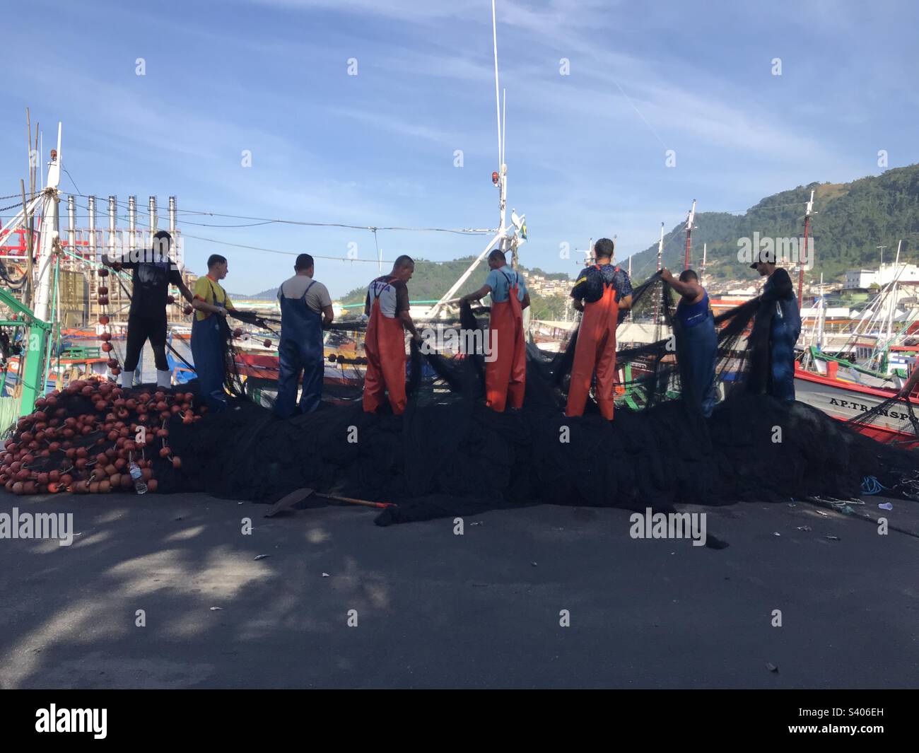 fishermen arranging the fishing net in the port of Angra dos Reis, Rio de Janeiro, Brazil - Smartphone Captured Stock Image