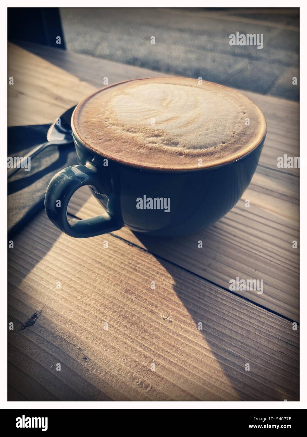 Relaxing with a flat white coffee in a cafe and looking out the window on a sunny day in Dumfries, Scotland. - Smartphone Captured Stock Image