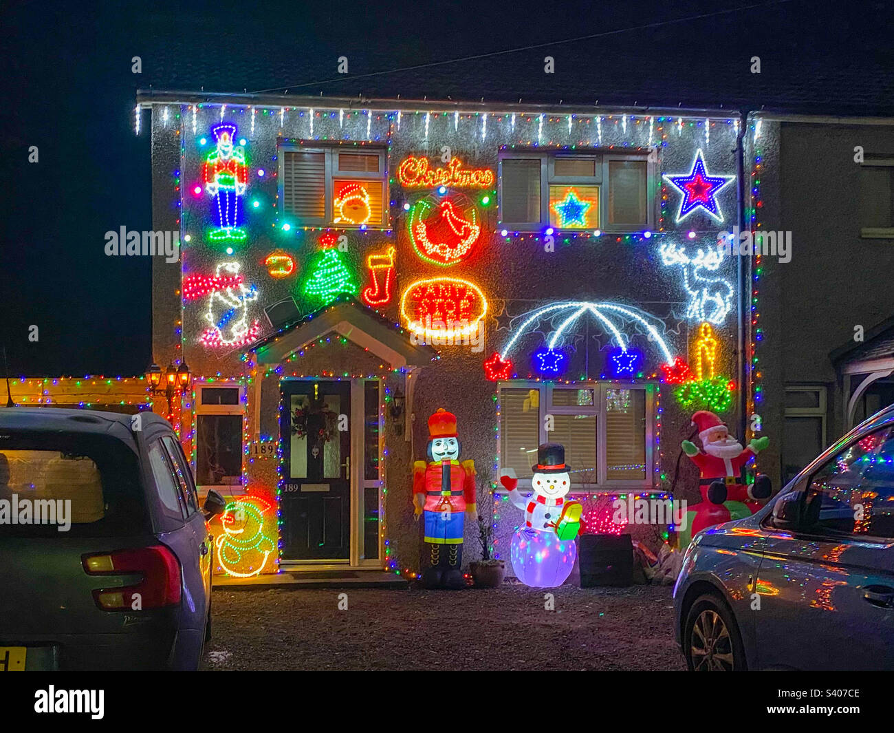 A house decorated with lots of colourful Christmas lights and decorations. - Smartphone Captured Stock Image