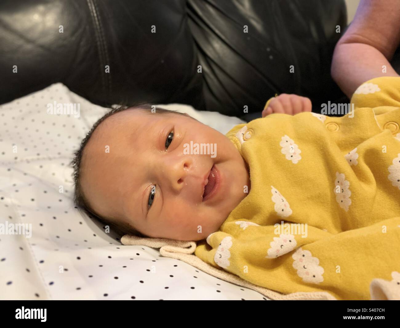 Seven days old premature baby reflex smiling. Jaundice Stock Photo