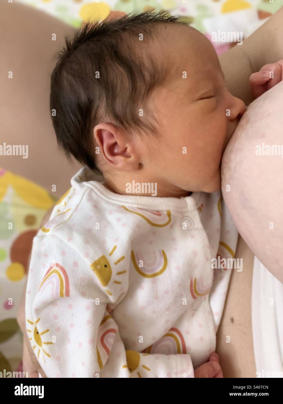 Baby being breastfed. Premature baby breastfeeding. Preterm infant - Smartphone Captured Stock Image