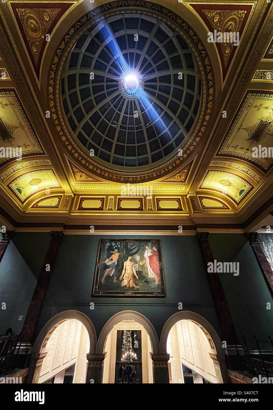 The entrance or exit to London’s National Gallery - the main Hall looks out to Trafalgar Square where we see the Norwegian Christmas Tree lights through the doors - Smartphone Captured Stock Image