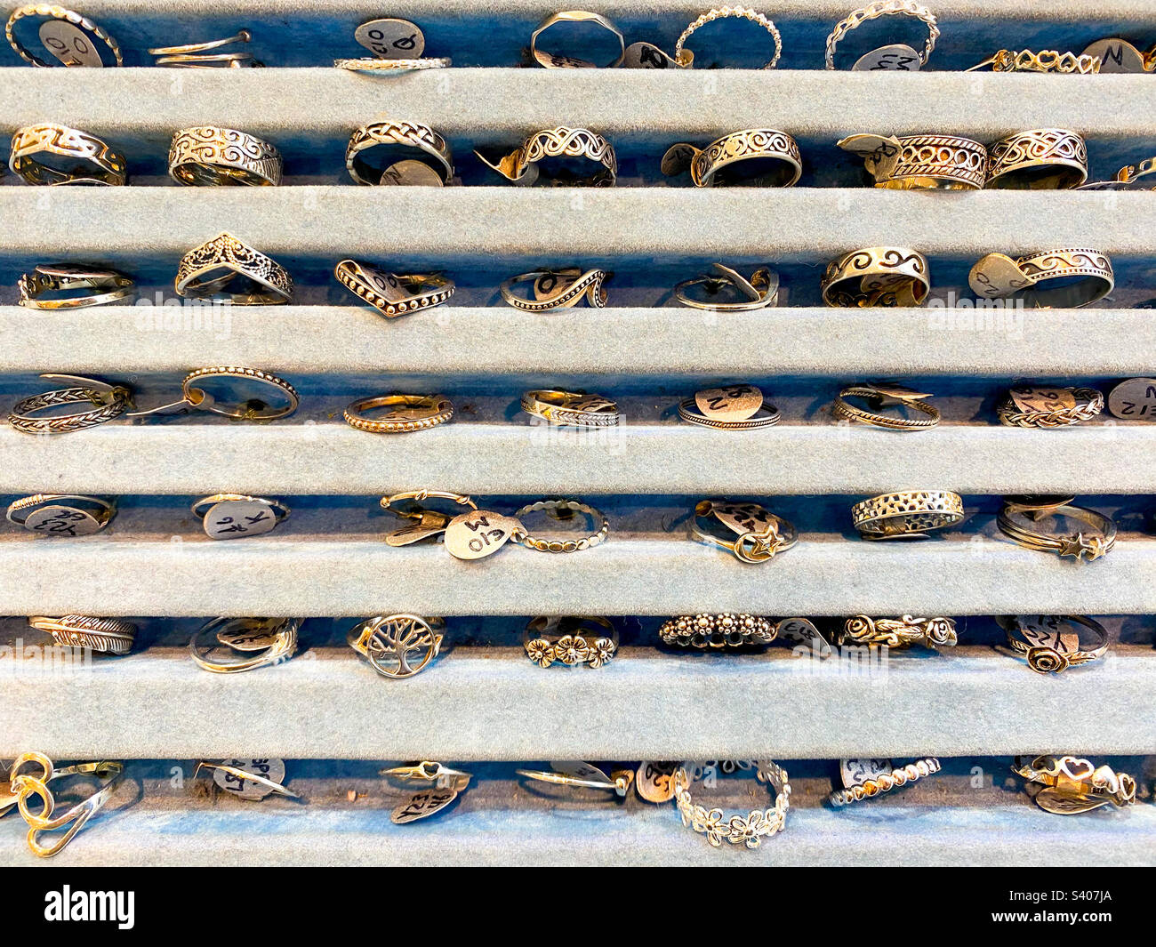 Silver rings on display on a jewellery shop. Stock Photo