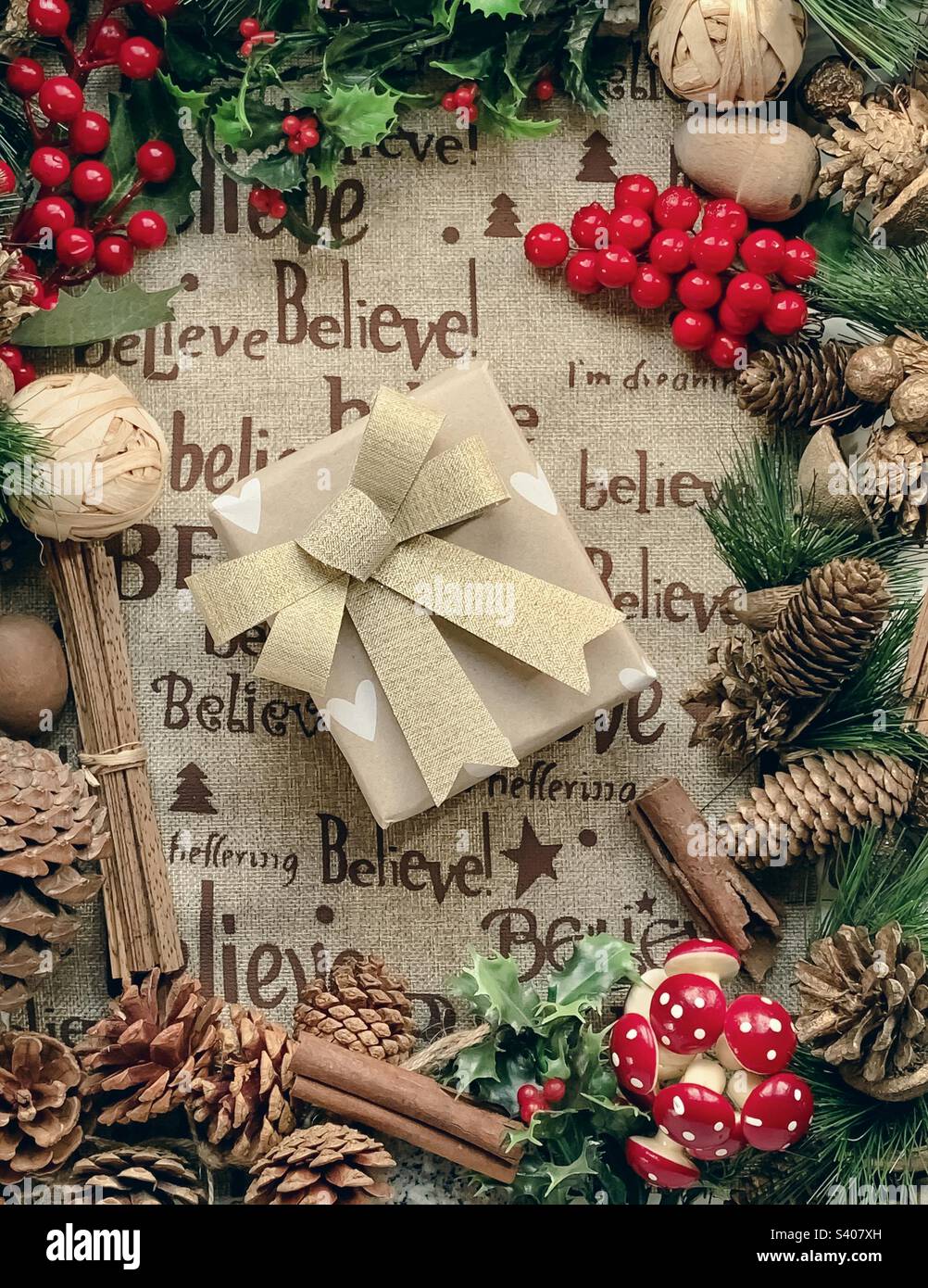 Festive flat lay of decorations centred around a wrapped present - Smartphone Captured Stock Image