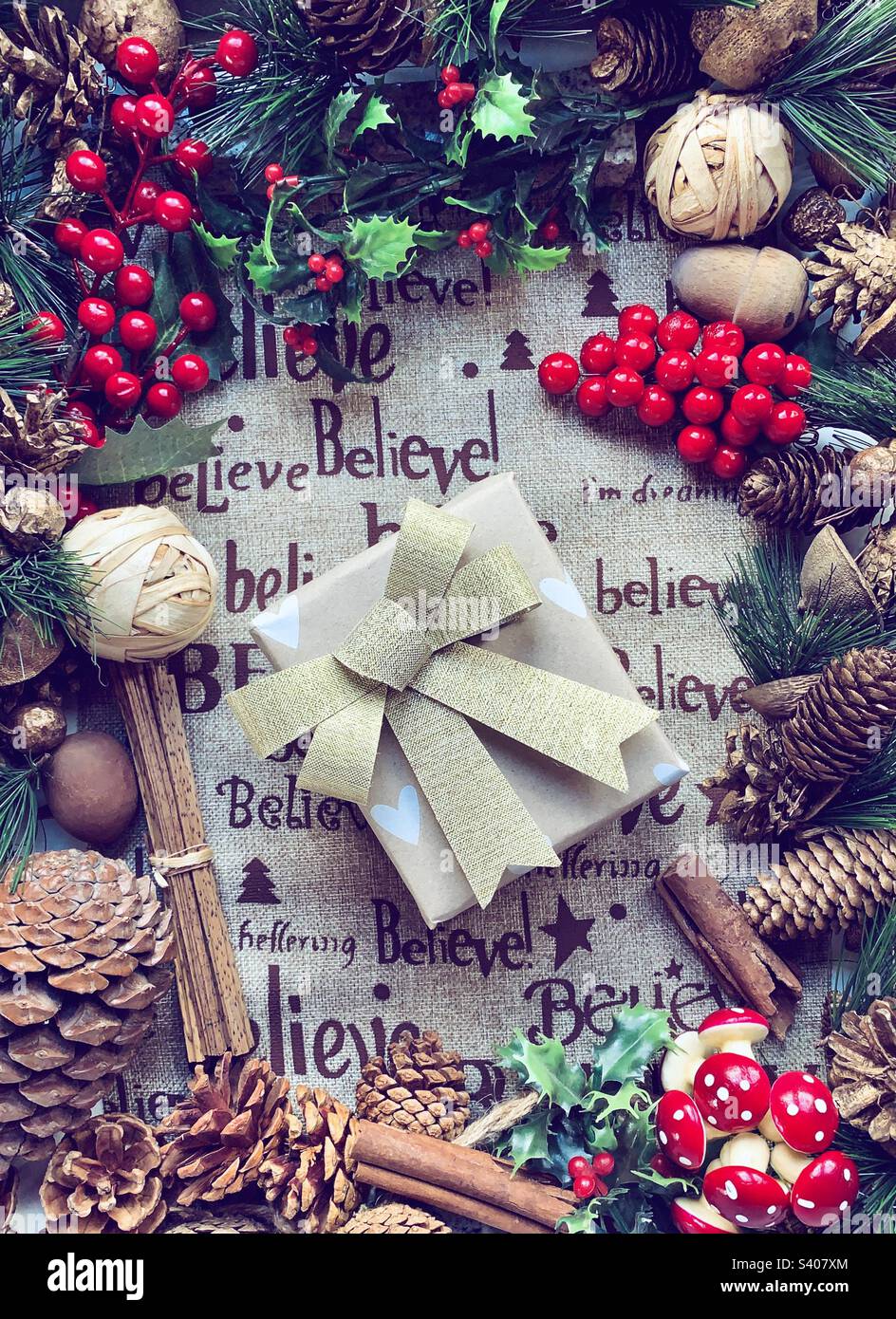 Festive flat lay of decorations centred around a wrapped present - Smartphone Captured Stock Image
