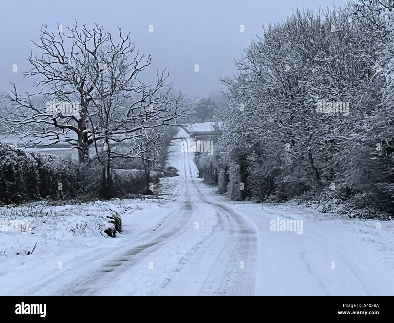 Snow fall during day has covered country roads in the Cotswolds on Sunday 11th December 2022 - Smartphone Captured Stock Image