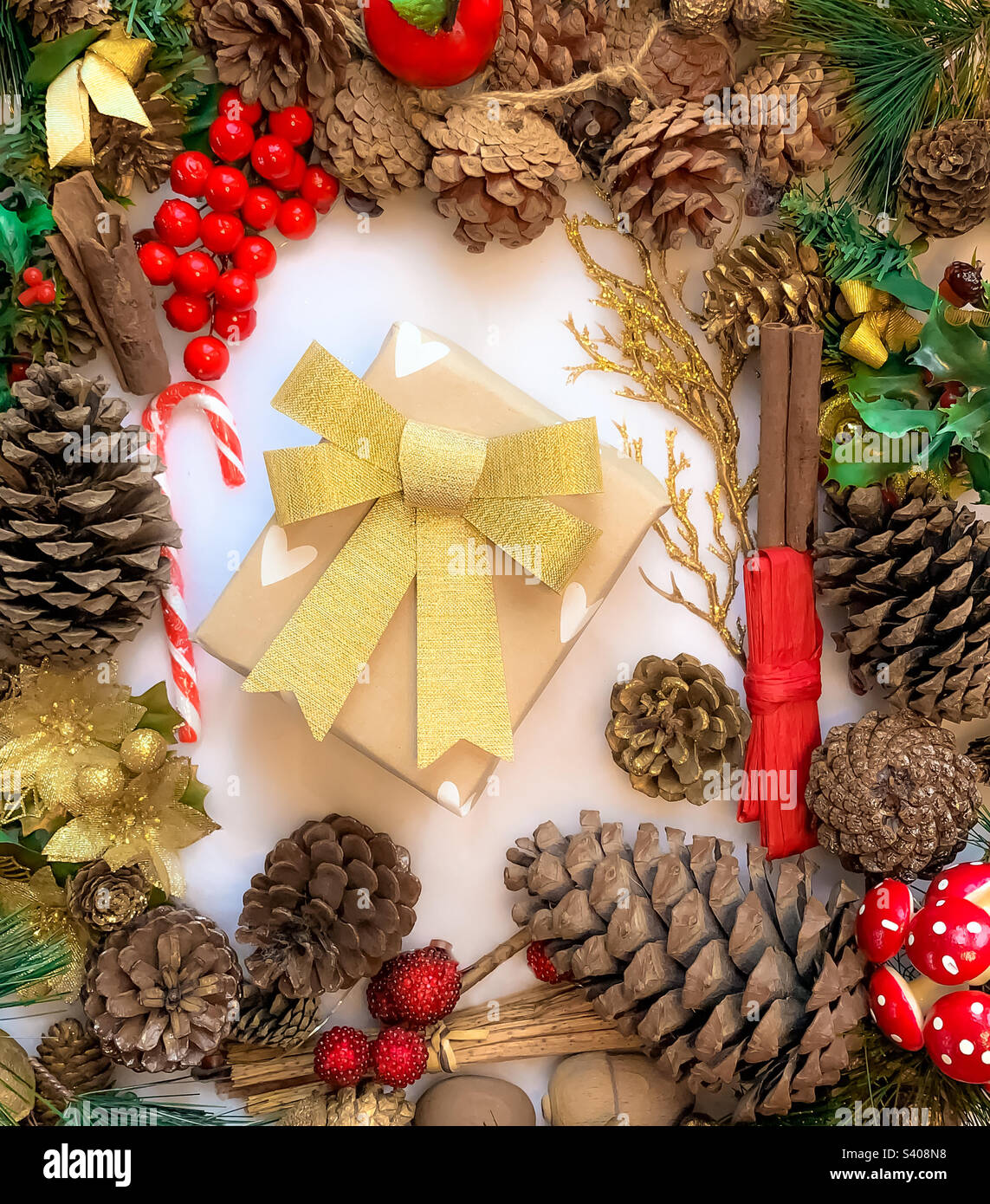 Festive flat lay of decorations centred around a wrapped present - Smartphone Captured Stock Image