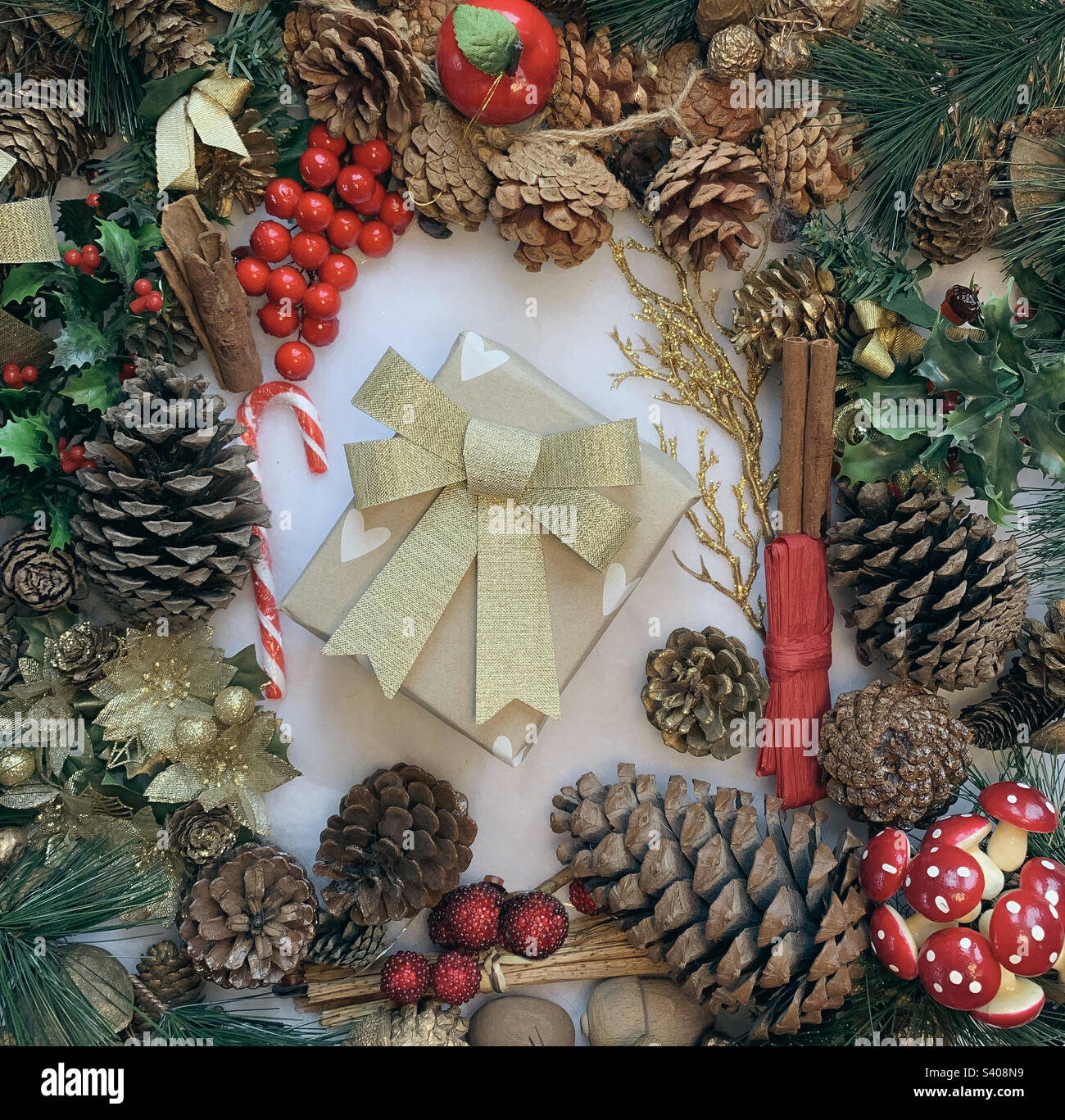 Festive flat lay of decorations centred around a wrapped present - Smartphone Captured Stock Image