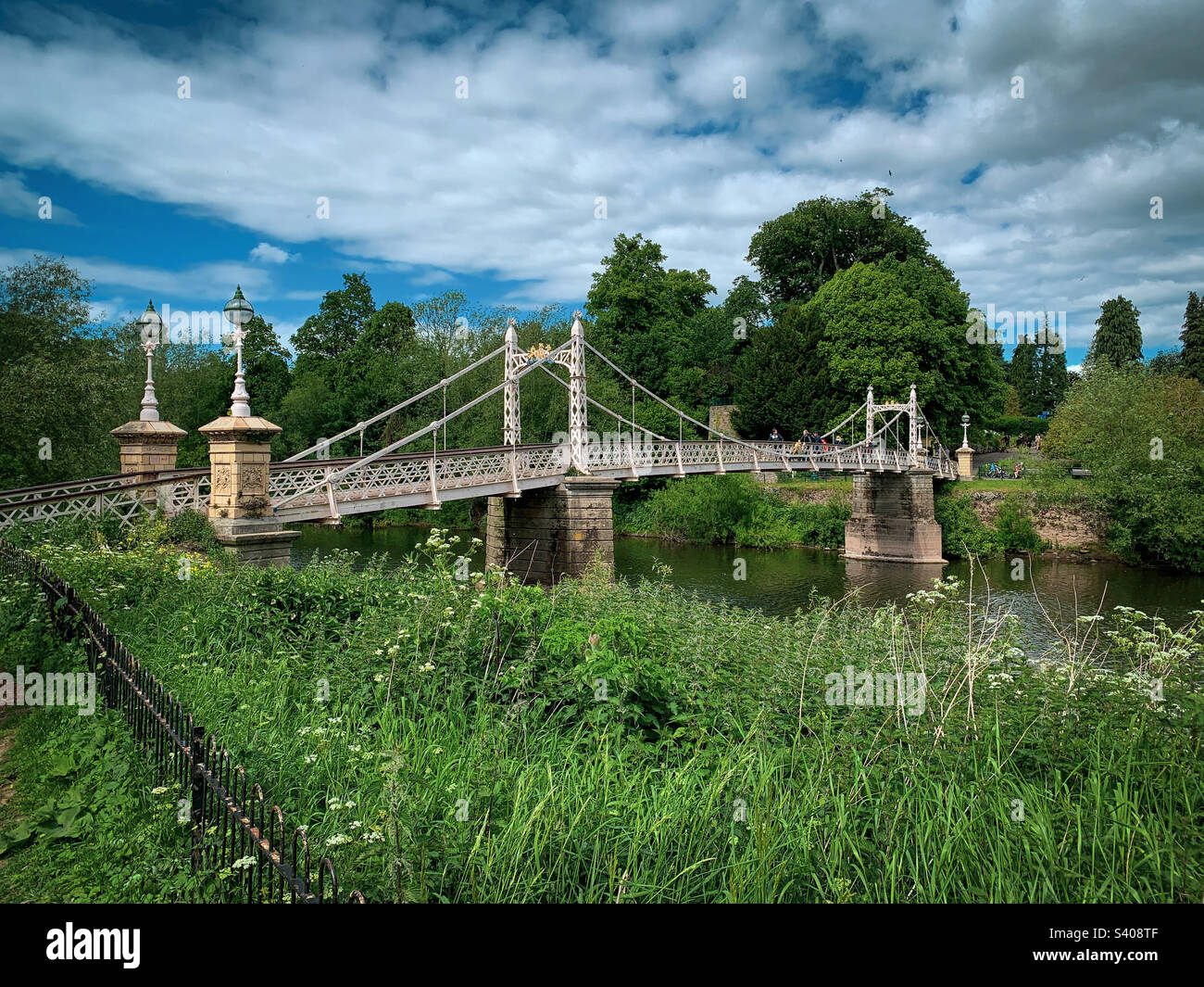 24th May 2022 - Hereford, UK: Ornate Victoria Bridge across the River Wye in Hereford is a foot-bridge opened in 1898 to commemorate the 1897 Diamond Jubilee of Queen Victoria. A mobile phone photo with some phone or tablet post processing. - Smartphone Captured Stock Image