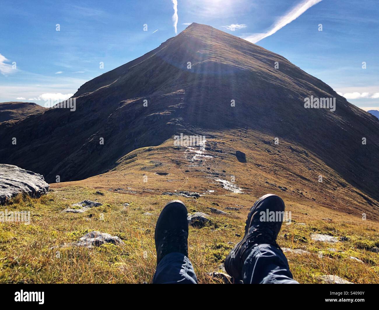 Looking towards Munro Stob Binnein with a View of walkers feet and leather boots from the bealach between Ben More and Stob Binnein, Crianlarich Scotland - Smartphone Captured Stock Image