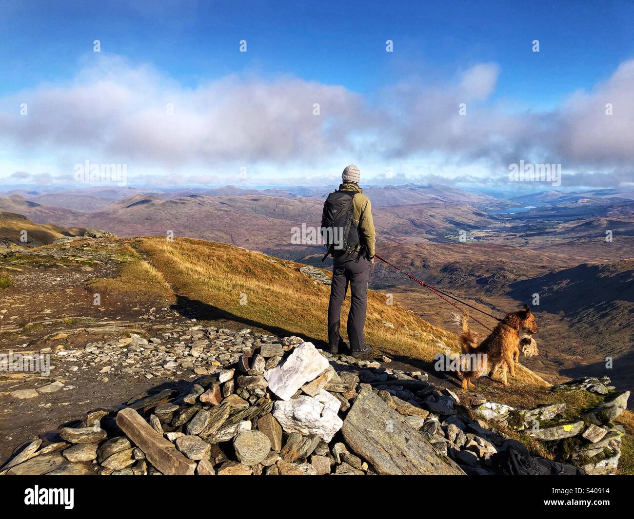 Man and two dogs on the summit of Munro Stob Binnein, Crianlarich Scotland - Smartphone Captured Stock Image