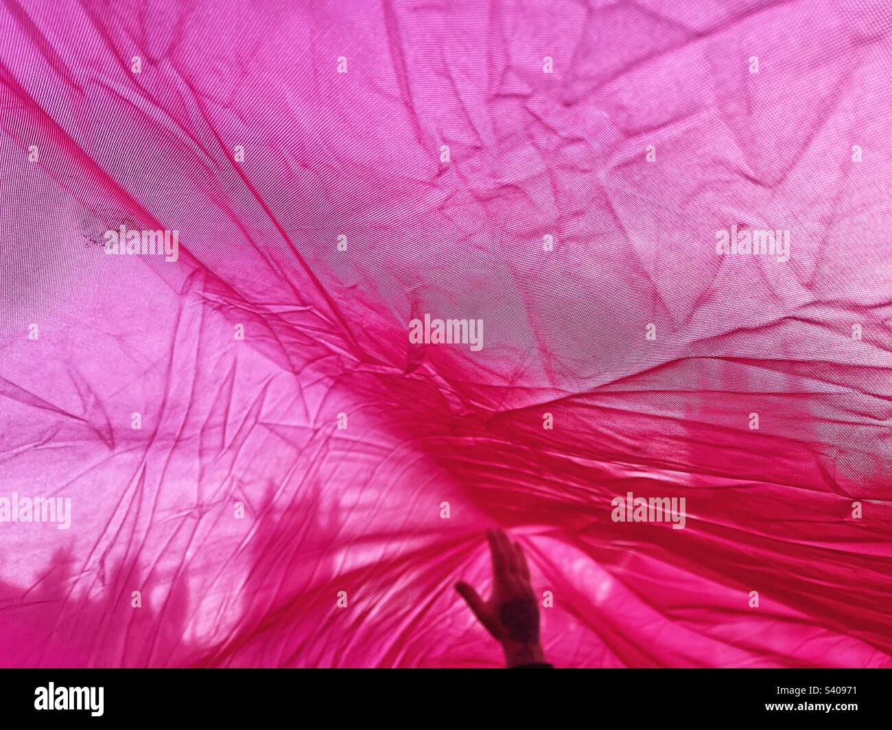 Hand holds up giant pink flag as postal workers demonstrate in Parliament Square London SW1 calling for fair pay - CWU trade union demonstration and protest December 2022 news - Smartphone Captured Stock Image