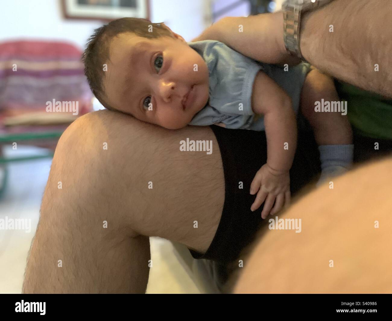 baby being massaged on father’s lap. burping your baby Stock Photo Alamy