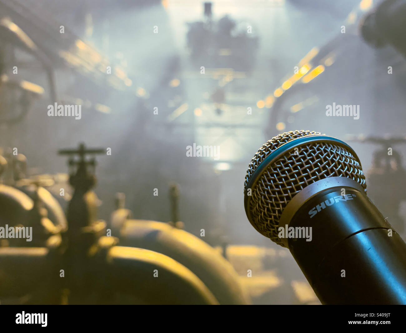 Closeup of a microphone on a stage in a factory - Smartphone Captured Stock Image