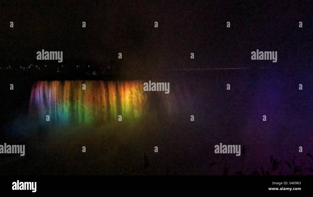 Rainbow colour lights shine on the Horseshoe Falls at night in Ontario, Canada. Stock Photo