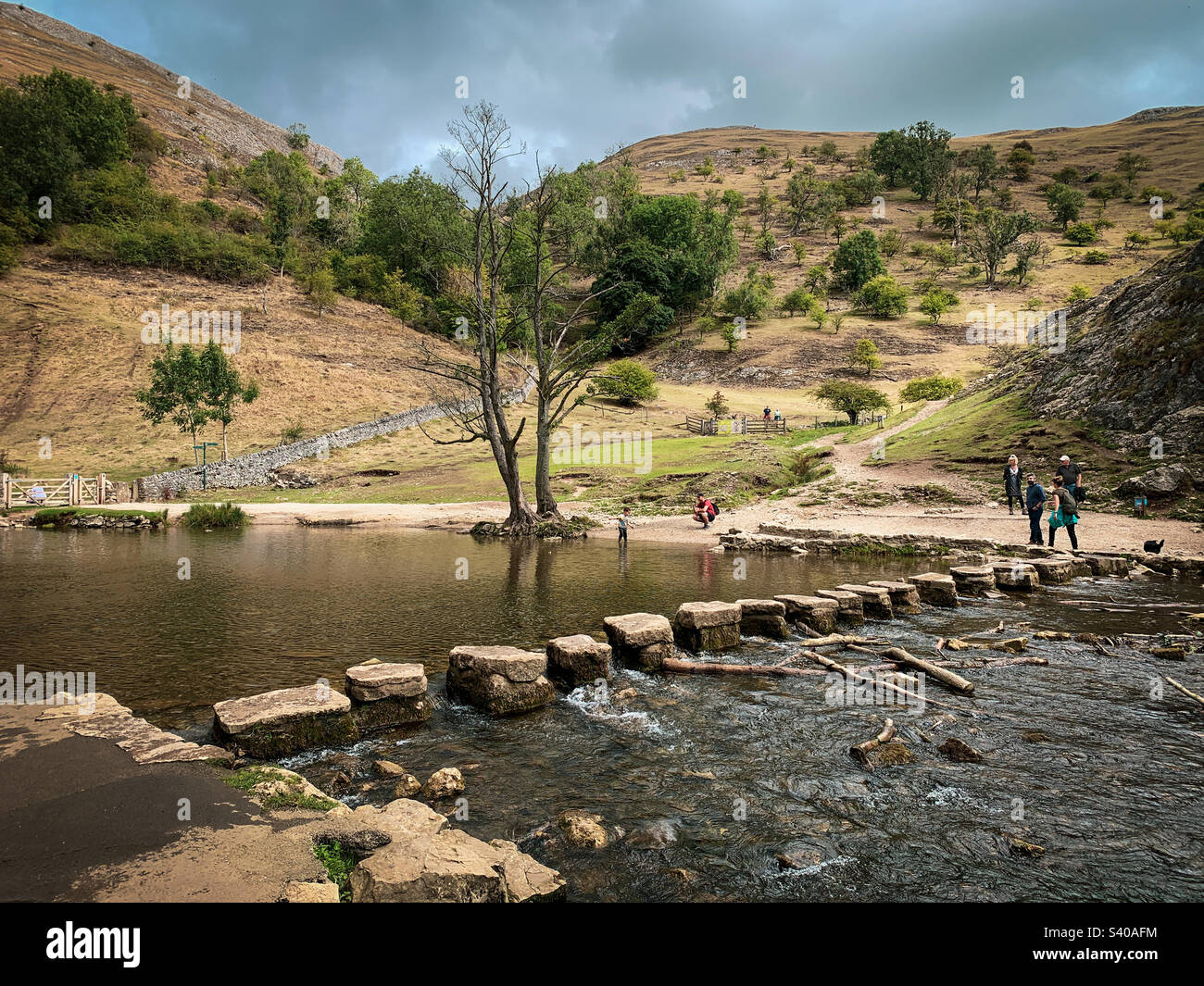 The iconic Dovedale stepping stones on the River Dove near Ilam, Derbyshire, UK, in the Peak District National Park in early autumn - Smartphone Captured Stock Image