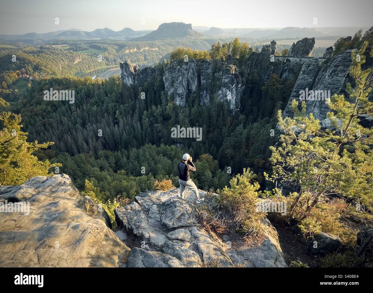 Photographer taking picture of Bastei Bridge, Saxony Switzerland mountains, Germany - Smartphone Captured Stock Image