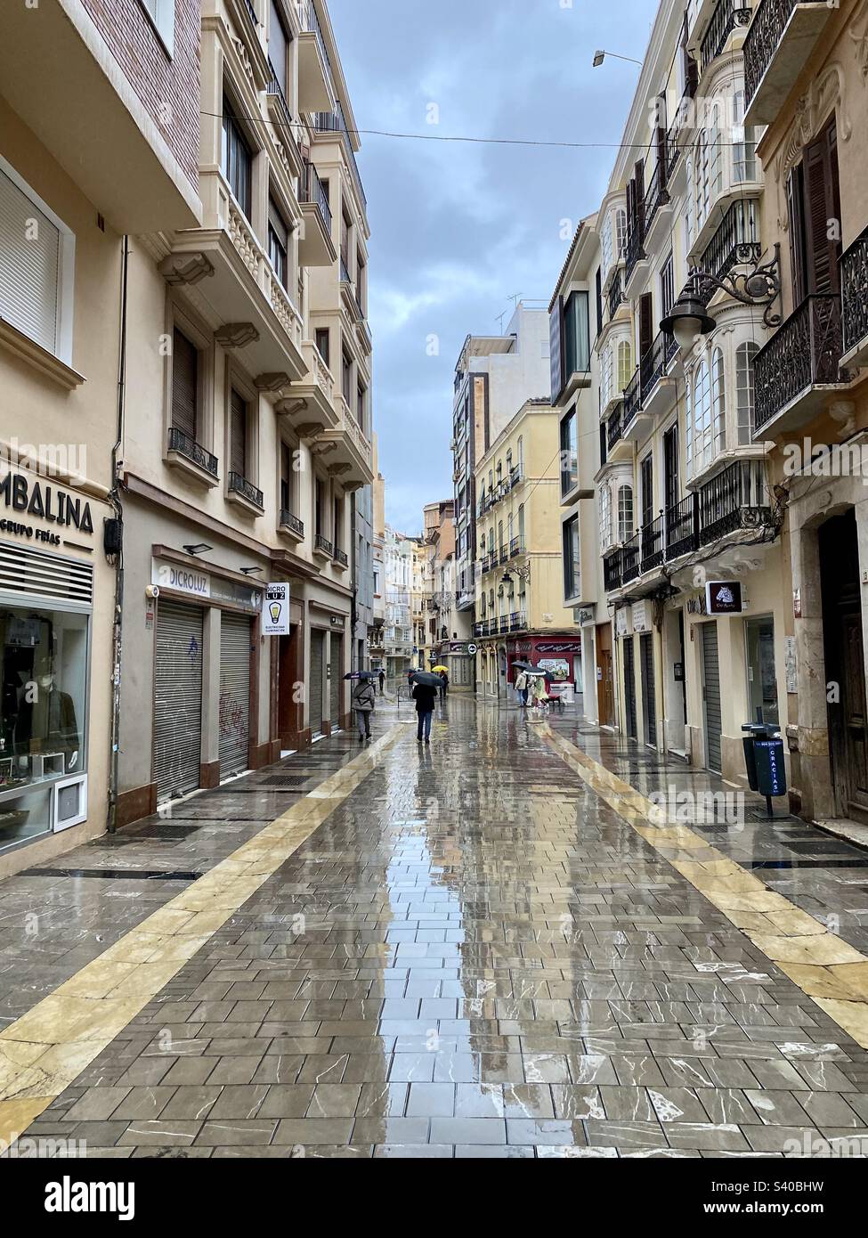 Malaga, Spain 11 December 2022; Calle Cisneros, a street in old town Malaga on a wet rainy day - Smartphone Captured Stock Image