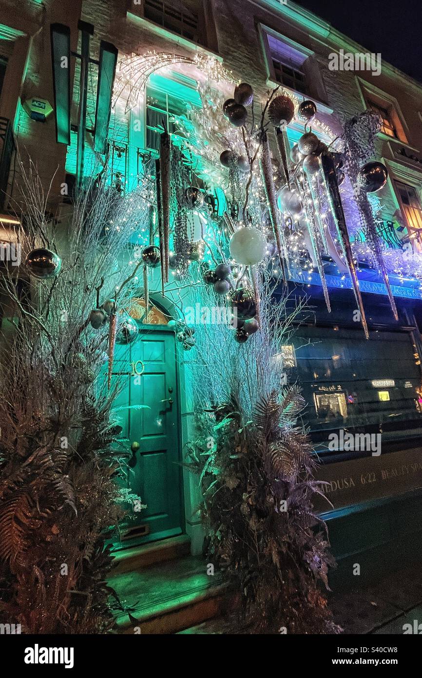Christmas decorations outside a shop property in London blue lights and icicles at night - Smartphone Captured Stock Image