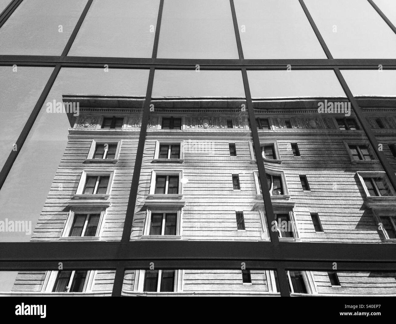 Reflection in window, showing another building in Boston, Massachusetts, USA.  Black and white photo. - Smartphone Captured Stock Image