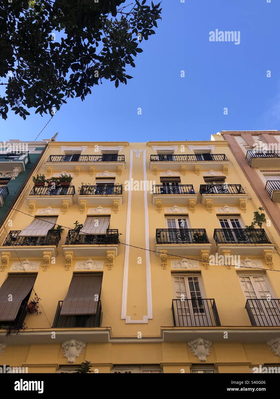 Brightly coloured block of flats in central Valencia Spain - Smartphone Captured Stock Image