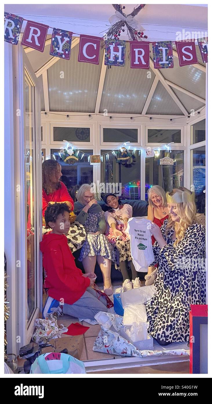 A family exchanging gifts at Christmas. - Smartphone Captured Stock Image