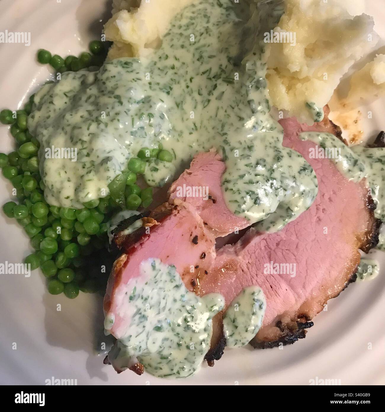 Baked ham, mash potato, peas and parsley sauce - Smartphone Captured Stock Image