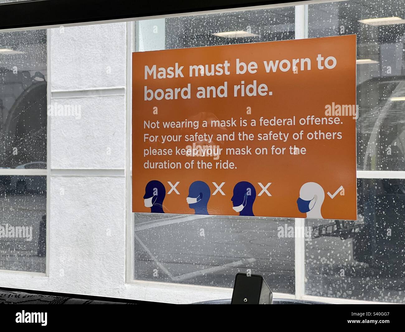 LOS ANGELES, CA, JUL 2022: sign on bus window instructing passengers to wear a mask, and how to wear it, during Covid-19 pandemic - Smartphone Captured Stock Image