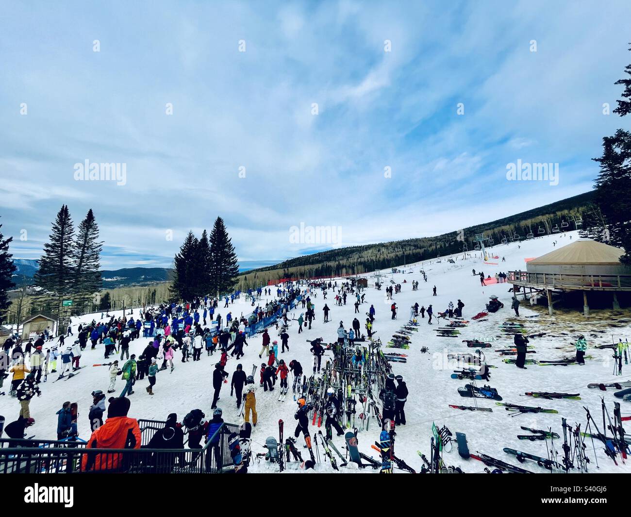 Wide angle view pointing skis, stretching colorful crowd lines and
